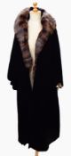 A vintage velvet evening coat with a fur collar, labelled "Marshall and Snelgrove, St Anne's Place,