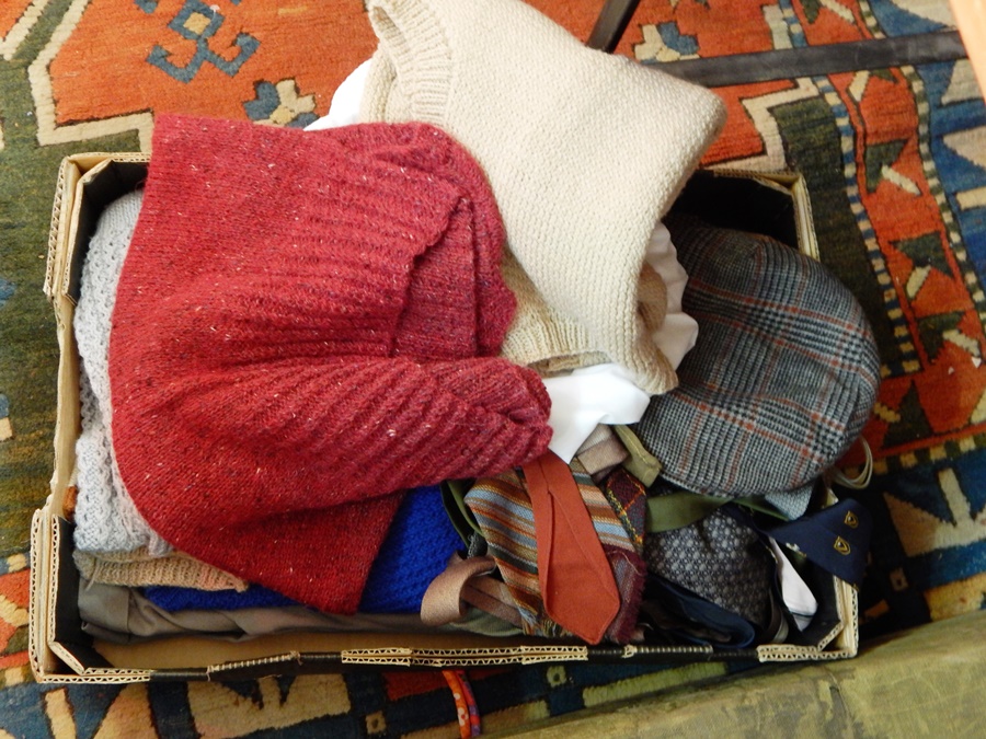 A quantity of gentlemens knitted waistcoats, tweed flat caps, braces, ties, trousers, etc.