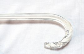 A glass walking cane, flat to one side, slight barleytwist to point of handle,