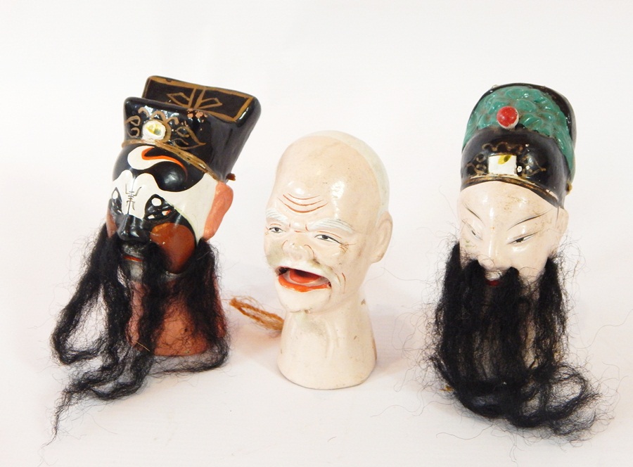 Six Chinese painted clay puppet doll heads with applied hair and beards and a Japanese paper
