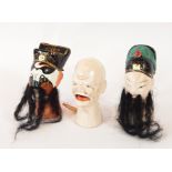 Six Chinese painted clay puppet doll heads with applied hair and beards and a Japanese paper