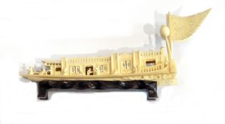 Japanese carved ivory houseboat on a carved wooden stand with two ivory animals,