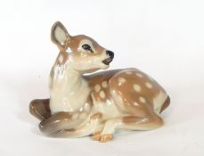 A Royal Copenhagen porcelain model of a deer seated, No.