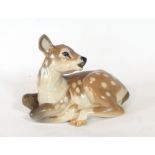 A Royal Copenhagen porcelain model of a deer seated, No.