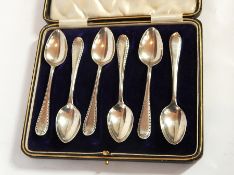 A set of six George V silver coffee spoons with bright cut engraved borders, Sheffield 1932,