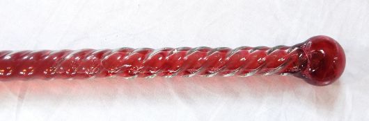 A glass walking cane barleytwist to surface, integral knob, filled with red liquid,