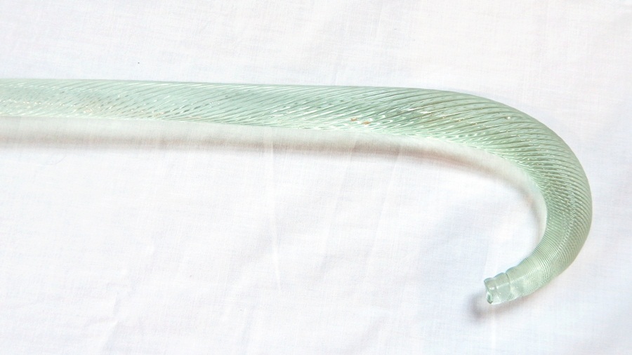 A glass walking cane, twisted detail to the surface,