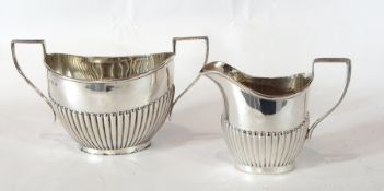 George V silver two-handled oval sugar basin with half fluted body,