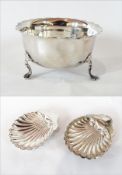 A late Victorian silver sugar bowl with cut card borders, plain form, raised on pad feet,