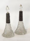 A pair of Edwardian silver-collared cut glass scent bottles, foliate scrollwork design,