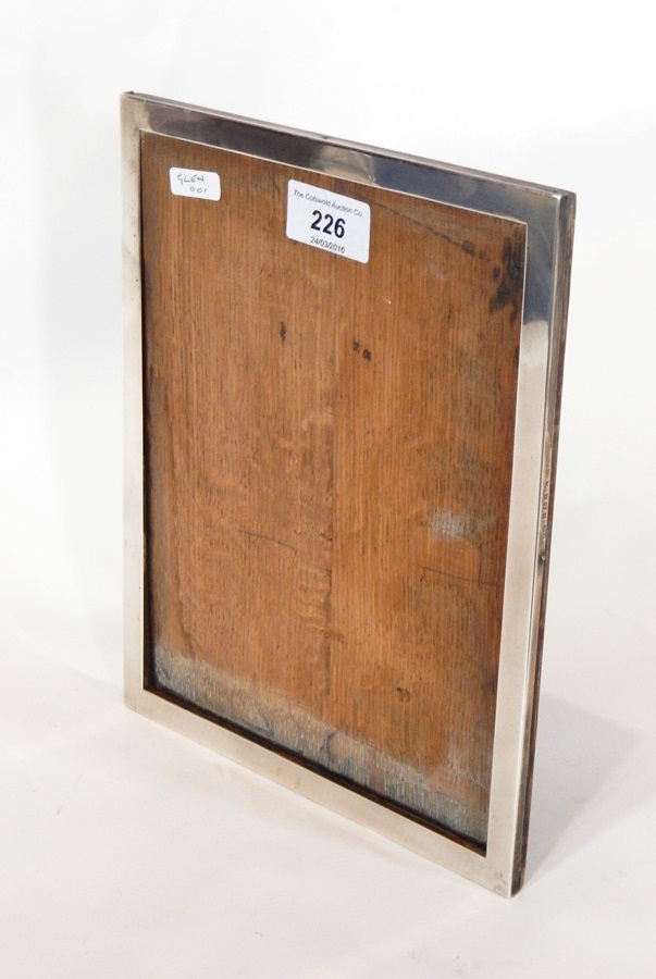 A George V silver rectangular photograph frame of plain form, on easel support, Birmingham 1934,