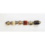Victorian silver and agate bracelet having three carved scalloped and shaped rectangular agate