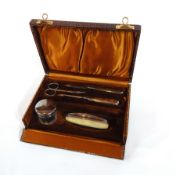 A silver-mounted vanity set to include pot, scissors, nail files and nail buffer, Birmingham 1928,