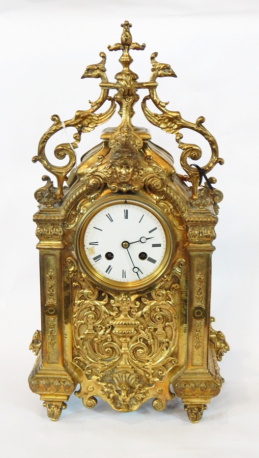 French Japy Freres-style gilt brass mantel clock with ornate foliate scroll and mask decoration,