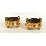 A pair of Chinese bronze shallow two handled censers, possibly Xuande,