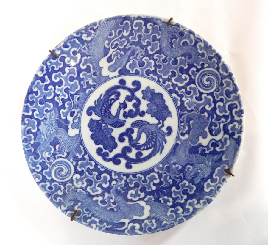 Pair Japanese chargers decorated in underglaze blue with phoenix, cloud scroll and dragon borders,