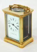 A French carriage clock timepiece, the brass case with glazed panels,