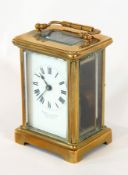 A French carriage clock timepiece, the brass case with glazed panels,