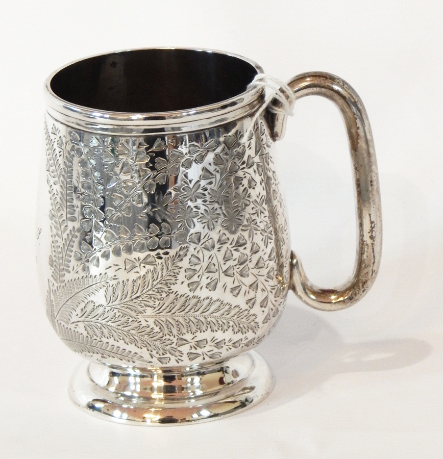 A Victorian silver cup with foliate engraving, on a raised circular foot, Birmingham 1898,