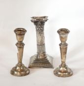 A pair of modern silver candlesticks, of cylindrical tapering form raised on a circular foot,