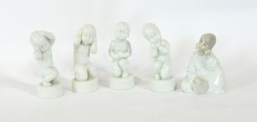 Four Royal Copenhagen porcelain figures of babies and a porcelain cherub