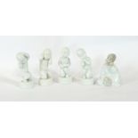 Four Royal Copenhagen porcelain figures of babies and a porcelain cherub