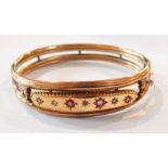 Edwardian 9ct gold and ruby/garnet bangle, twin reeded bands set four pink stones, Chester 1908,