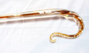 A glass coloured walking cane with brown inclusion,