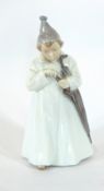 A Royal Copenhagen porcelain figure of a child in a long white robe, umbrella and hat, No.