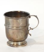 A silver christening mug with raised rim, C-scroll handle, raised girdle, raised on a circular foot,