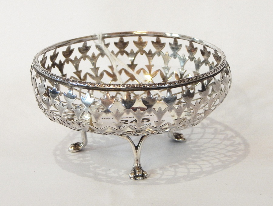 A George V silver bonbon dish with pierced threadwork decoration, raised on pad feet,