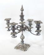 A silver plate candelabrum with twisting arms and a pair of silver plate candlesticks