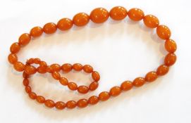 String of orange amber-type graduated beads