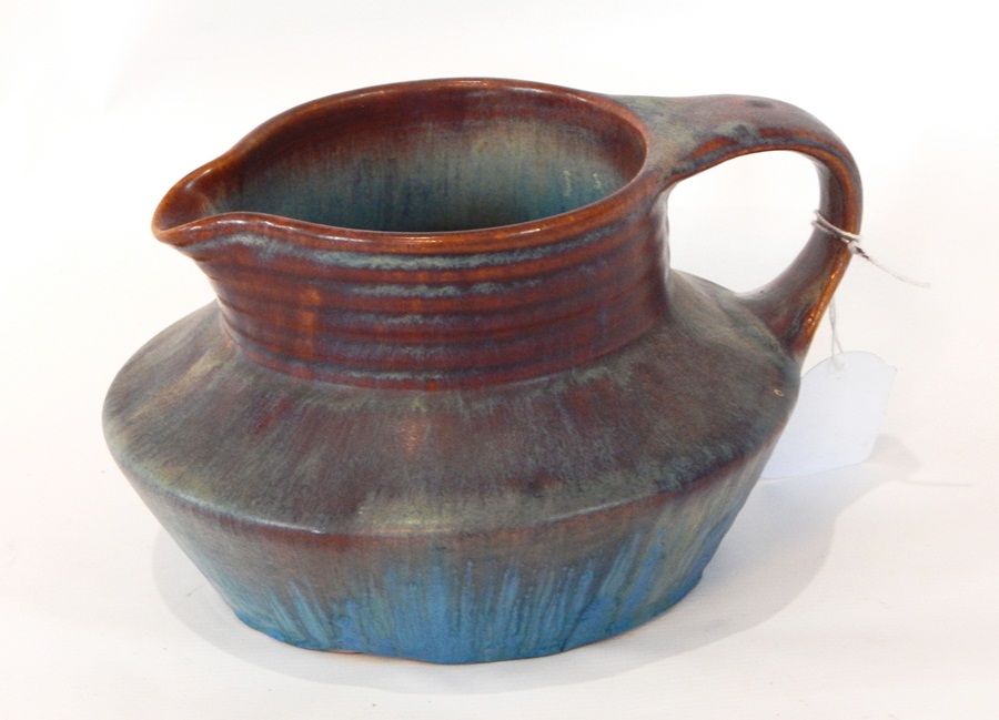 A Bourne Denby jug with mottled red and purple/blue decoration,