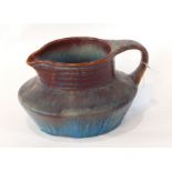 A Bourne Denby jug with mottled red and purple/blue decoration,