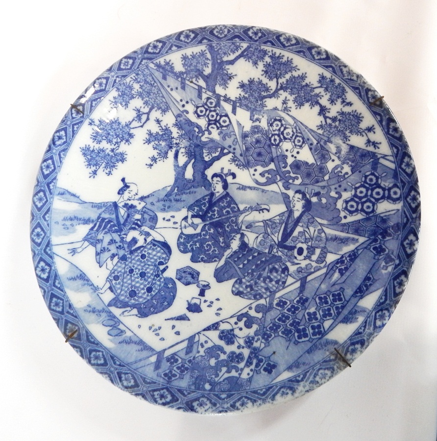 Japanese porcelain charger decorated with musical figures and tea ceremony in garden,