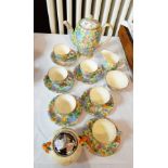 A Royal Winton part tea service decorated in floral pattern with gilt rim and a Clarice Cliff