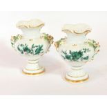 A pair of Meissen small vases decorated with green floral pattern on white ground and ceramic roses