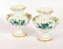 A pair of Meissen small vases decorated with green floral pattern on white ground and ceramic roses