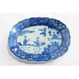 A Chinese underglaze blue and white plate of wavy and shaped oval form having floral panels to