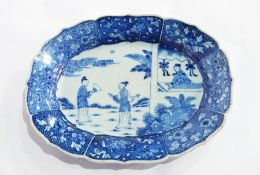 A Chinese underglaze blue and white plate of wavy and shaped oval form having floral panels to