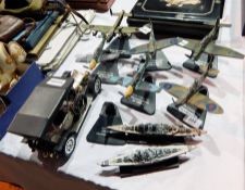 A collection of diecast WWII model airplanes together with a model of the Bismarck and Hood and a