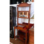 An Edwardian mahogany hall stand, with mirror back and spindle supports, scroll brass hangers,