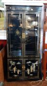A black lacquered chinoiserie style display cabinet,