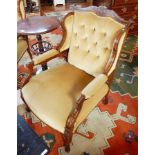A pair of Edwardian button back armchairs, the crest rail with floral inlay, padded arms,