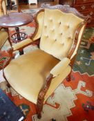 A pair of Edwardian button back armchairs, the crest rail with floral inlay, padded arms,