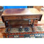 An oak drop flap sofa table, with moulded edge top,