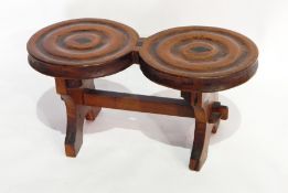 An antique child's stool with twin roundel top, on trestle supports,