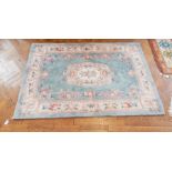 A wool wash Chinese carpet with blue field, floral decoration,
