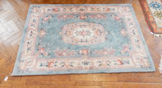 A wool wash Chinese carpet with blue field, floral decoration,